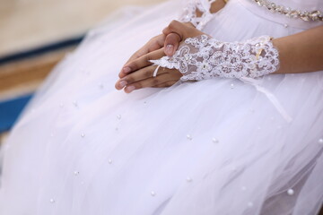 holy communion, hands of girl in lace gloves