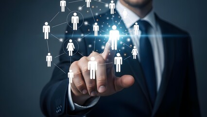 Businessman interacting with a glowing digital network of human resources icons on a dark background