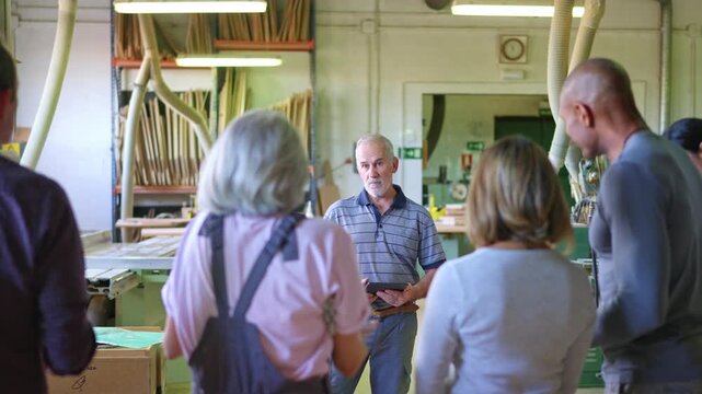 Senior manager listening to worker complaining in a workshop
