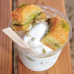 a traditional Middle Eastern dessert made with pistachios and puff pastry "baklava", with soft ice cream