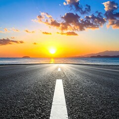 Asphalt road stretches to a vibrant sunset over a tranquil ocean (1)