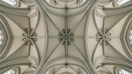 Gothic church vaulted ceiling with intricate details and stained glass