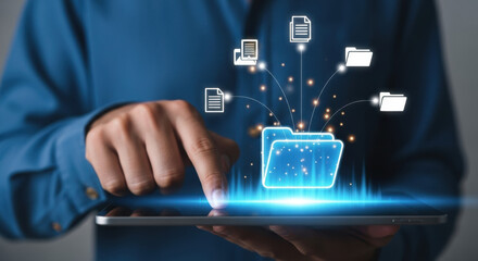 Close-up of a person's hand touching a tablet screen displaying a glowing blue digital interface for document management with organized folders and files.