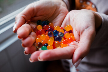 Glass beads in hand, multi-colored.