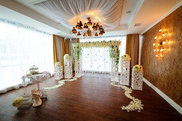 flower arch from fresh colors for a wedding ceremony at restaurant on a white background with a light wedding decor.