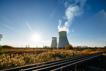 Nuclear power plant after sunset. Dusk landscape with big chimneys.