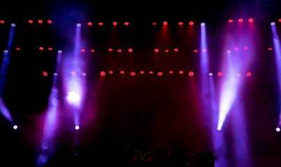 Stage light with colored spotlights and smoke.