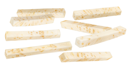 studio photograph of arranged white cheese sticks with brown spots against a stark black backdrop displaying dairy and food ingredients for cooking