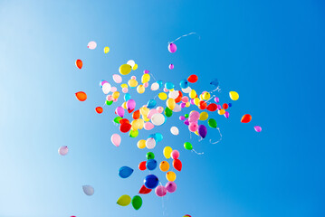 Flying balloons in blue sky with clouds © fotofrol
