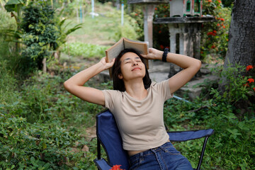 Woman reading and writing in the garden.