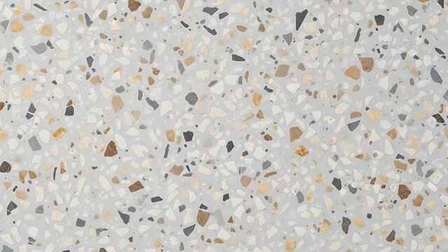 Close-up view of a terrazzo surface with small, multicolored stone chips in a predominantly white and beige background.