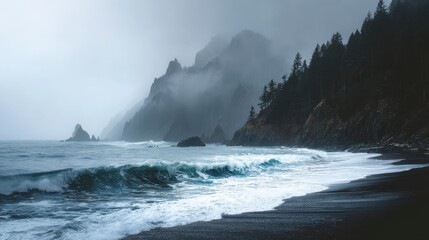 A moody coastal scene with dark sand beach, foamy waves, foggy mountains, and scattered trees. The sky is overcast, with dramatic contrast