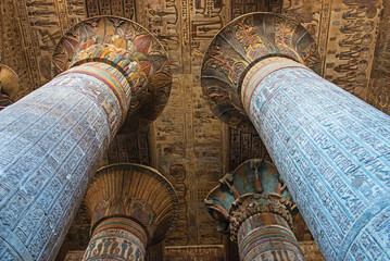 Hieroglypic colorful painting carvings on column wall at the ancient egyptian Temple of Khnum in Esna Egypt with ornate decoration