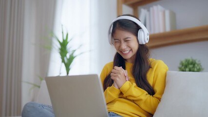 Funny euphoric young asian woman celebrating winning or getting ecommerce shopping offer on computer laptop. Excited happy girl winner looking at notebook celebrating success