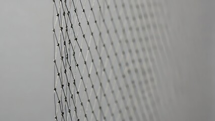 Close-up of a metal mesh screen with a blurred background