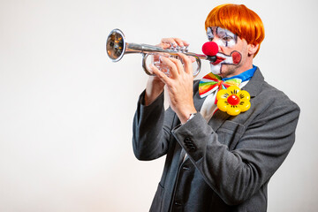Clown playing trumpet, creating fun music performance