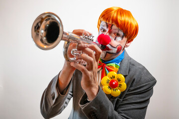 Clown playing trumpet at a performance
