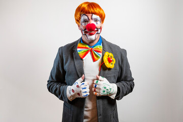 Clown performing wearing colorful bowtie and orange wig