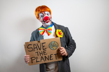 Man clown costume holding save the planet sign