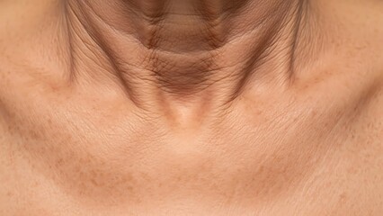 Fototapeta premium Close-up of a mature womans neck showing wrinkles and skin texture.