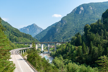 Alpine mountain valley with bridge and river in Alpe Adria motorway region