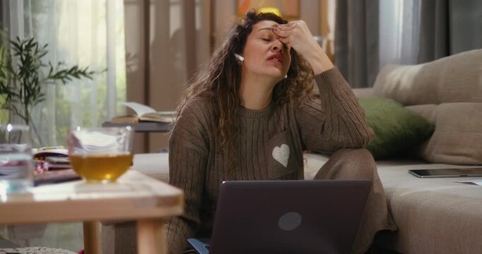 Mother argues during business conference call on a laptop while her daughter and dog interrupt in the background seeking attention. Work from home stress, parenting challenges, and family distraction