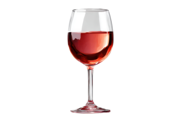 A clear glass filled with red wine stands on a table casting a shadow in soft light during a relaxed evening gathering