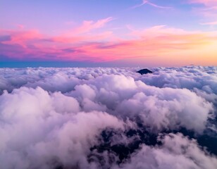 Aerial view of a mountain peak emerging from a sea of fluffy clouds at sunset