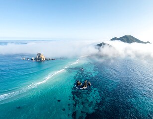 Aerial view of a stunning coast, crystal clear water, and hazy clouds