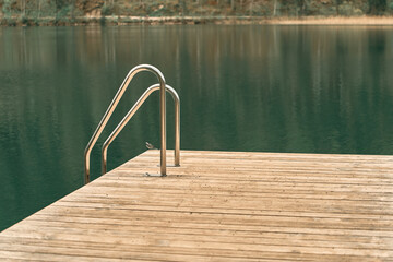 Relaxing mountain lake scene with wooden dock © AlexGo