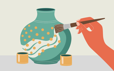 This image portrays a hand painting a decorative pottery vase with vibrant colors and patterns, highlighting the artistic expression and creativity involved in pottery.