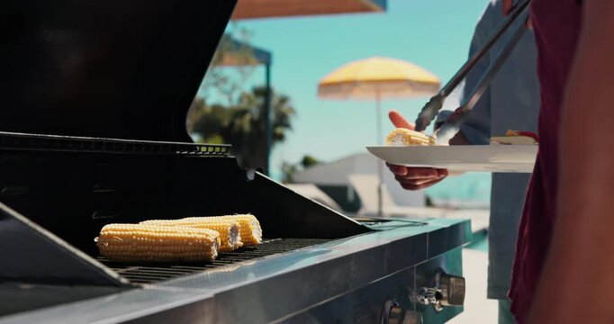 Barbecue, corn and friends with hands of person outdoor for cooking, celebration and lunch. Nutrition, bbq hangout and health with people and cookout event on patio of home for food and vegetables