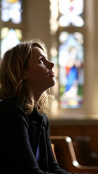 Profile view of a devout woman quietly praying inside a sacred chapel, bathed in colorful light from beautiful stained glass windows, deep contemplation, spiritual reflection.