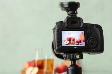 Apples with juice on camera screen in photo studio, closeup