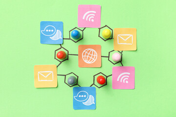 Connected pins with networking symbols on green background. Link concept