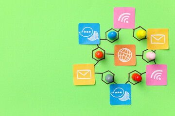 Connected pins with networking symbols on green background. Link concept