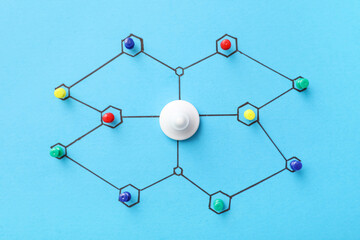 Connected pins on blue background. Link concept