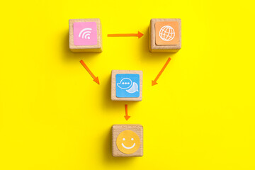 Connected cubes with smile and networking symbols on yellow background. Link concept