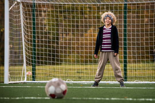 Boy goalkeeper ready to save a ball during a soccer match.