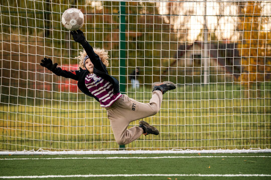 Boy goalkeeper ready to save a ball during a soccer match.