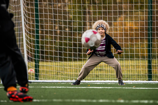 Boy goalkeeper ready to save a ball during a soccer match.