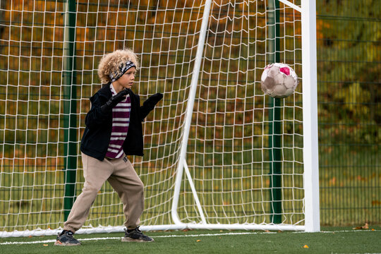 Boy goalkeeper ready to save a ball during a soccer match.