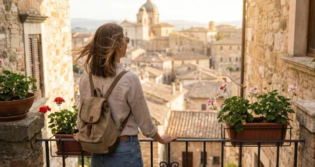 Sierkussen Smal steegje Young woman standing on balcony looking at view of ancient Italian village street with old stone houses and terracotta roofs  © STOCK-AI