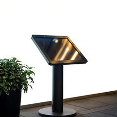 Modern digital display stand with sleek design and illuminated screen next to a potted plant on a tiled floor