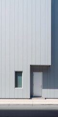 Fototapeta premium Minimalist exterior of a modern building featuring a single door and a small window against a light gray facade.