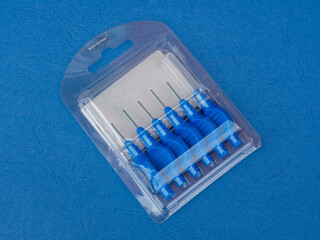 New design inderdental brush for adults. Pack of blue interdental brushes. Dental and oral hygiene and health 