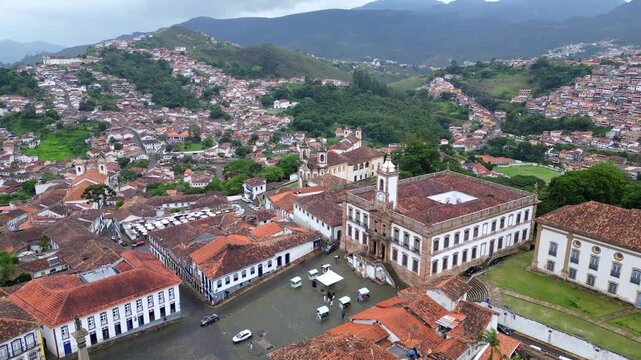 Ouro Preto, Brazil: Aerial drone footage of Tiradente museum situated in Ouro Preto townsquare, old town of Brazil with the museum and Bas&iacute;lica Nossa Senhora do Pilar in the center. WIth the mou