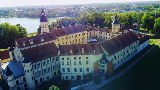Nesvizh Castle - a top view of a medieval castle in autumn, Belarus. A landscape with a palace surrounded by a moat on a sunny autumn day. The Radziwill Family Castle from a bird's-eye view. 4К