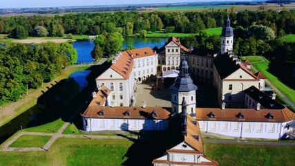 Nesvizh Castle - a top view of a medieval castle in autumn, Belarus. A landscape with a palace surrounded by a moat on a sunny autumn day. The Radziwill Family Castle from a bird's-eye view. 4К