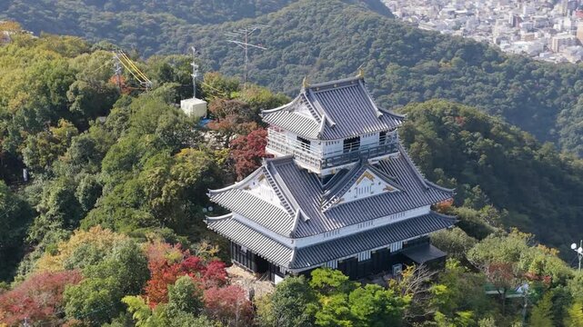 Aerial drone close-up of Gifu Castle in autumn daylight, Mount Kinka, Japan 岐阜城